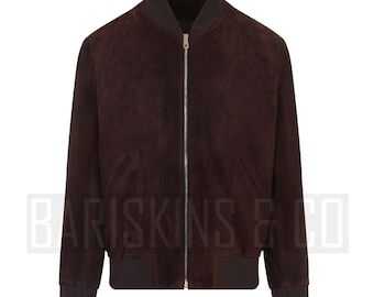 May include: A dark brown suede bomber jacket with a zipper closure, ribbed cuffs, and a ribbed hem. The jacket has a dark gray collar and pockets. The brand name "BARISKINS & CO" is visible at the bottom of the jacket.