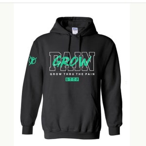 May include: Black hooded sweatshirt with the words "PAIN GROW" in white and green lettering. The phrase "GROW THRU THE PAIN" is below the main text, with "G.T.T.P" underneath. A green graphic is on the left sleeve.