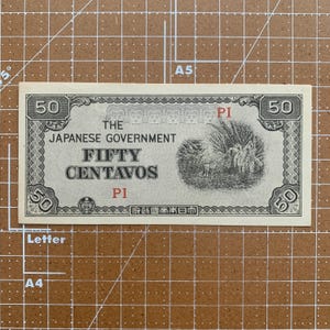May include: A vintage Japanese government fifty centavos note. The note is primarily light green with black text and illustrations. The text includes "The Japanese Government" and "Fifty Centavos". The note has the number "50" in each corner.