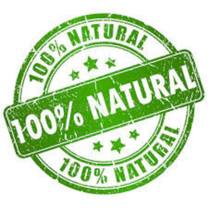 May include: Green round stamp with the text "100% NATURAL" in white lettering. The stamp has a distressed, worn look.