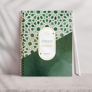 May include: Green and gold Ramadan journal with a spiral binding. The cover features an intricate geometric pattern and the text "Ramadan with Purpose: 30 Days for Prayer & Growth for a Meaningful Month".