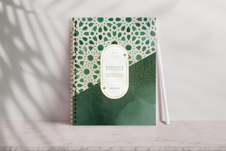 May include: Green and gold Ramadan journal with a spiral binding. The cover features an intricate geometric pattern and the text "Ramadan with Purpose: 30 Days for Prayer & Growth for a Meaningful Month".