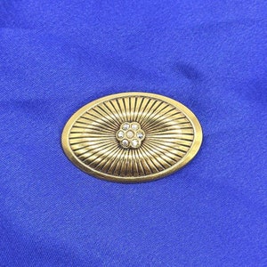 Golden color brooch with rhinestones