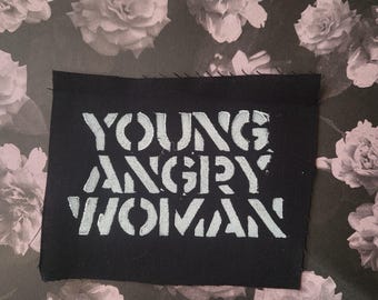 Young angry woman punk cloth patch