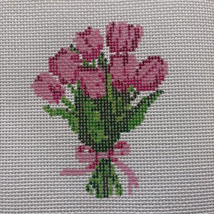 May include: A cross-stitch design of a bouquet of pink tulips tied with a pink ribbon. The tulips have varying shades of pink, and the leaves are green. The background is a light gray fabric.