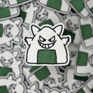 May include: White and green embroidered patch of a cartoon ghost shaped like a Japanese rice ball, with the text "Breaking BVNK" at the bottom.