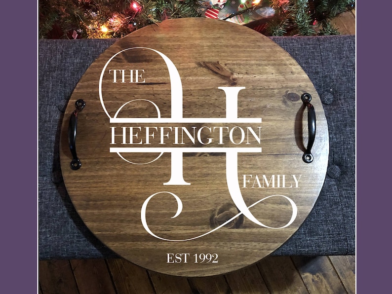 Whether you're looking to enhance your living room ottoman table or searching for the perfect  personalized gift, Our 18" round wood tray featuring a monogram name design that will add a personal touch to any space.