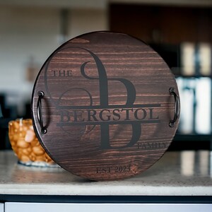 Whether you're looking to enhance your living room ottoman table or searching for the perfect  personalized gift, Our 18" round wood tray featuring a monogram name design that will add a personal touch to any space.