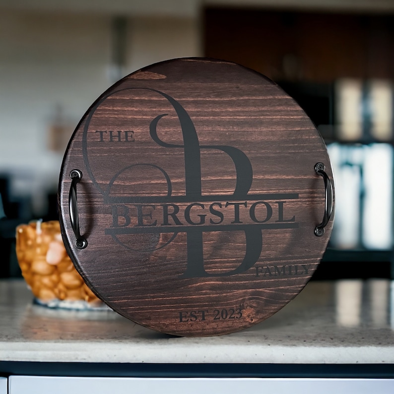 Whether you're looking to enhance your living room ottoman table or searching for the perfect  personalized gift, Our 18" round wood tray featuring a monogram name design that will add a personal touch to any space.