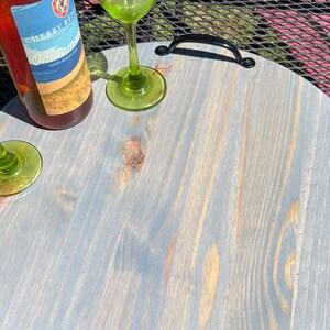 Whether you're looking to enhance your living room ottoman table or searching for the perfect  personalized gift, Our 18" round wood tray featuring a monogram name design that will add a personal touch to any space.