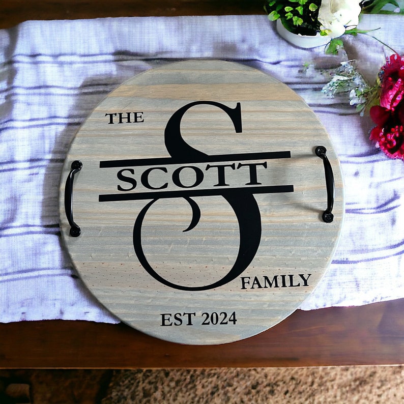Whether you're looking to enhance your living room ottoman table or searching for the perfect  personalized gift, Our 18" round wood tray featuring a monogram name design that will add a personal touch to any space.