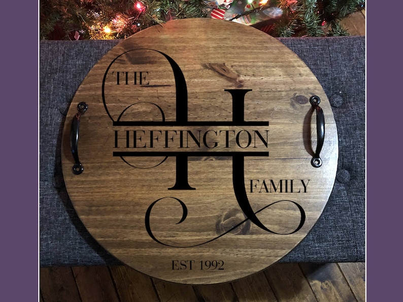 Whether you're looking to enhance your living room ottoman table or searching for the perfect  personalized gift, Our 18" round wood tray featuring a monogram name design that will add a personal touch to any space.