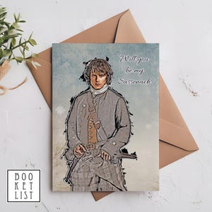 May include: A greeting card featuring a cartoon illustration of a man in a kilt and a plaid shirt. The text on the card reads "Will you be my Sassenach?"
