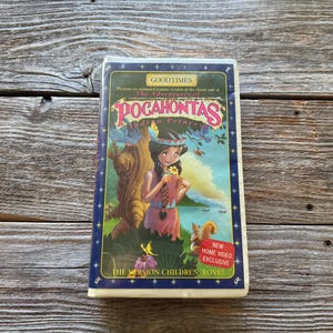 May include: A white ceramic mug with a black handle and the text "But First, Coffee" in a black, handwritten-style font. The mug is on a white surface.