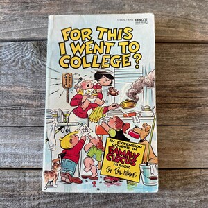 May include: A vintage paperback book titled "For This I Went to College?" features a colorful cartoon illustration. The cover art depicts a chaotic family scene with the text "An Extension Course in Family Circus Humor by Bil Keane."
