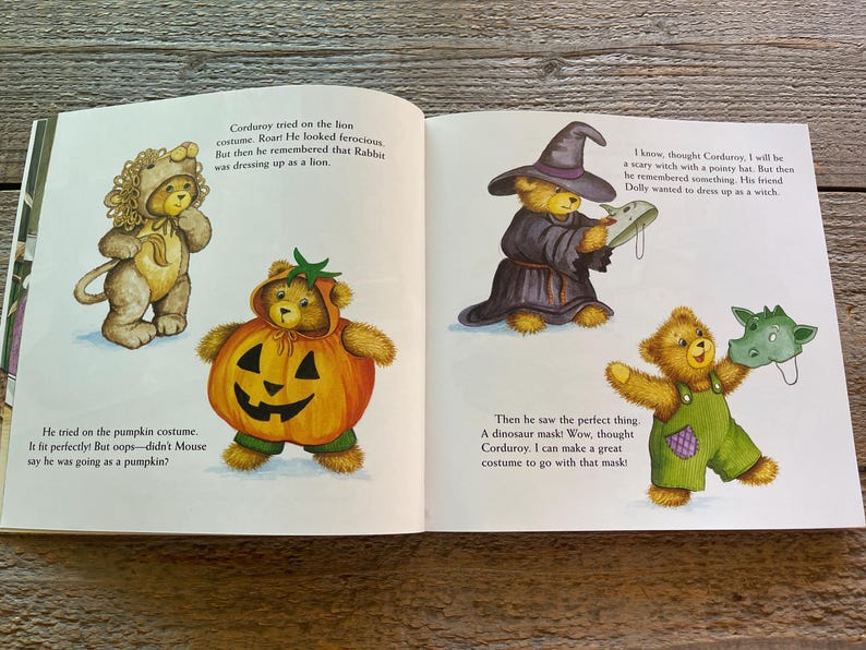 May include: A children's book illustration featuring a teddy bear dressed as a pumpkin, a teddy bear dressed as a lion, a teddy bear dressed as a witch, and a teddy bear wearing a dinosaur mask. The book is titled "Corduroy's Halloween."