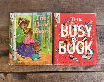 May include: Two vintage children's books, "The Three Bears" and "The Busy Book", both published by Rand McNally Elf Books. The covers feature colorful illustrations.