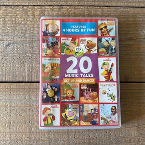 May include: A DVD case featuring a colorful collage of children's cartoon characters. The cover includes the text "20 Music Tales Get Up and Dance!" and "Features 4 Hours of Fun". The PBS Kids logo is also visible.