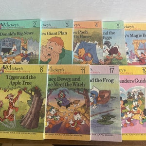 May include: A collection of 10 vintage Mickey's Young Readers Library books featuring various Disney characters such as Donald Duck, Winnie the Pooh, Tigger, and more. The books are in good condition with colourful covers and titles such as "Donald's Big News", "Tigger and the Apple Tree", and "Huey, Dewey, and Louie Meet the Witch".