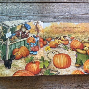 May include: An open book with an illustration of a bear and a dog picking pumpkins. The text on the page reads "It was almost Halloween.  Cobblestone and his friends were going really.  They want to pick out a pumpkin for Christopher's Halloween party."
