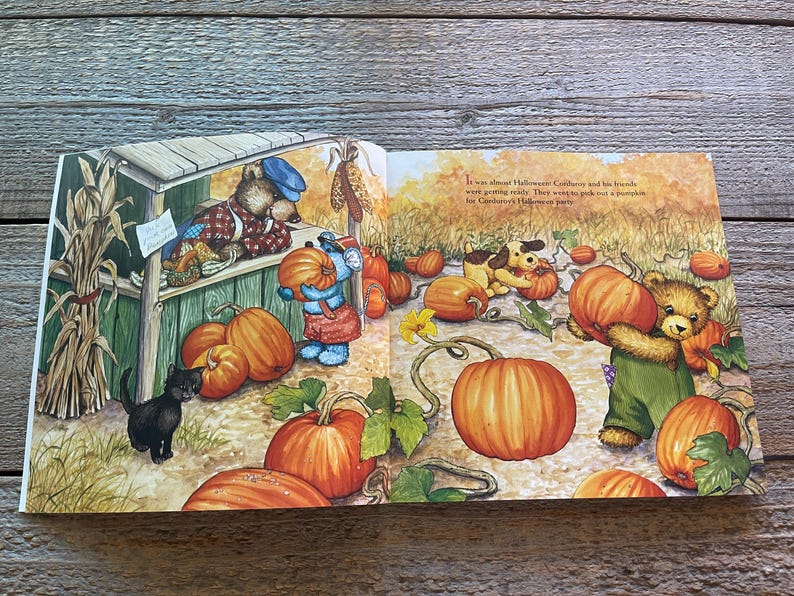 May include: An open book with an illustration of a bear and a dog picking pumpkins. The text on the page reads "It was almost Halloween.  Cobblestone and his friends were going really.  They want to pick out a pumpkin for Christopher's Halloween party."