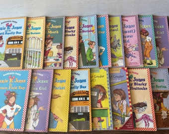 May include: A collection of 15 colorful paperback books featuring Junie B. Jones, a popular children's book character. The books have a checkered pattern and feature illustrations of Junie B. Jones and other characters from the series.