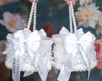 May include: Two white pearl-embellished boxes with satin bows and ribbon handles. The boxes are decorated with lace and have personalized ribbons with the text "Little Bride", "The Coco", "ZADIA", "Royal Princess", "TRACIA", and "6-28-23".