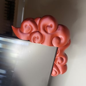 May include: A 3D printed red cloud-shaped corner shelf, perfect for adding a touch of whimsy to your home decor.