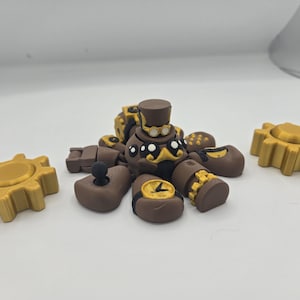May include: A brown and gold steampunk-themed toy with a clock face, gears, and a top hat. The toy is made up of multiple pieces that can be assembled and disassembled.