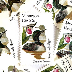 May include: A collection of six vintage Minnesota postage stamps featuring a common loon and a showy lady slipper flower. Each stamp is white with a green border and reads "Minnesota USA 20c".