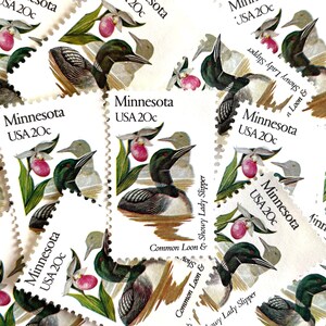 May include: A collection of vintage Minnesota postage stamps featuring a common loon and a showy lady slipper flower. Each stamp is 20 cents and features the text "Minnesota USA 20c".