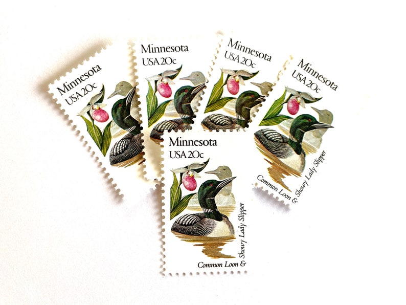 May include: Five vintage postage stamps featuring a common loon and a showy lady slipper orchid. The stamps are from Minnesota and are each valued at 20 cents.