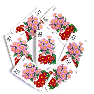 May include: A collection of eight vintage US postage stamps featuring a cluster of pink and red aster flowers. Each stamp has the text "32 USA" and "Aster" printed on it.