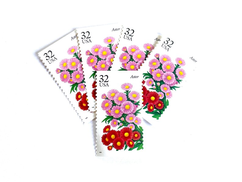 May include: Five vintage US postage stamps featuring a pink and red aster flower with the text "Aster" and "32 USA" on each stamp.