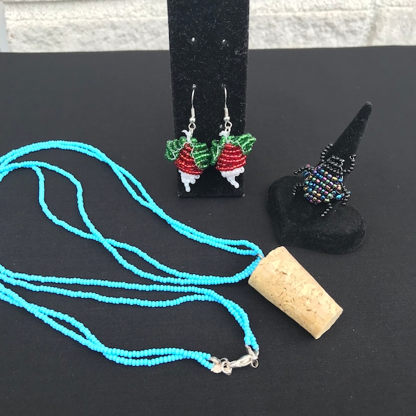 Boucles d'oreilles en perles de radis, collier de perles bleues avec un pendentif en liège et bague scarabée en perles noires et multicolores