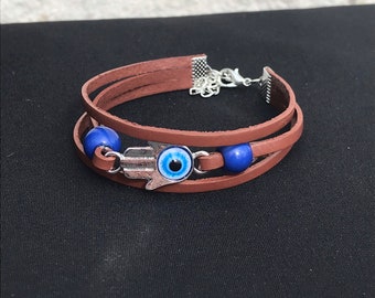 Ellie Dina’s Brown Leather Bracelet with Evil Eye Hand Charm and Blue Beads from The Last of Us Show/ Series