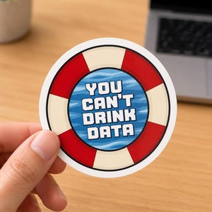 May include: A circular sticker featuring a red and white life preserver ring design surrounding a blue water-patterned center. The text "YOU CAN'T DRINK DATA" is printed in bold white block letters across the center of the sticker.