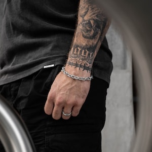 silver spiked chain bracelet on male wrist