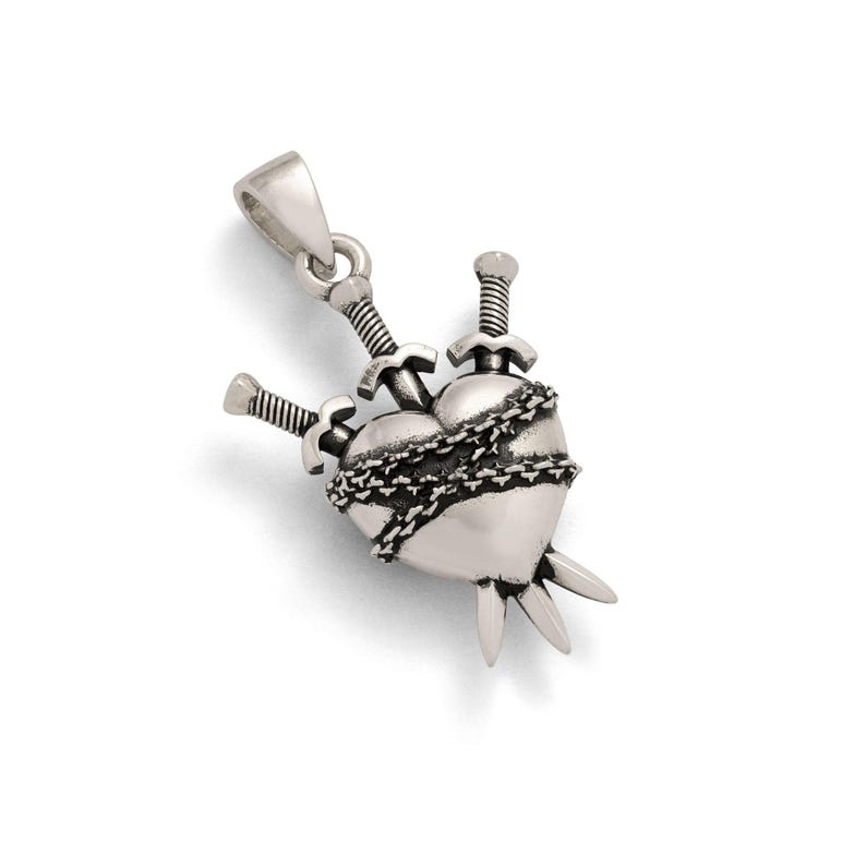 silver heart shaped pendant with 3 swords going through it and wrapped in chain