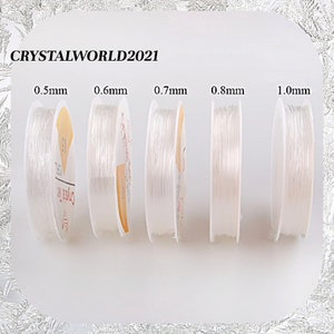 May include: Five spools of clear elastic string in different sizes: 0.5mm, 0.6mm, 0.7mm, 0.8mm, and 1.0mm. The spools are labeled with the size of the string.
