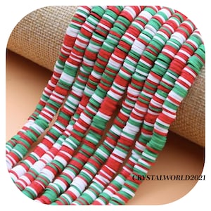 May include: A strand of colourful polymer clay beads in red, white and green. The beads are flat and round, and they are arranged in a repeating pattern. The beads are perfect for making jewellery or other crafts.