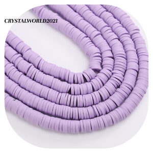 May include: A strand of lavender-coloured polymer clay beads. The beads are flat and round, resembling small discs. The beads are strung together to form a long necklace.