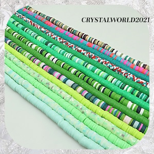 May include: Assortment of green, blue and white polymer clay beads. The beads are round and flat, and they are arranged in rows. The beads are perfect for making jewellery, crafts and other projects.