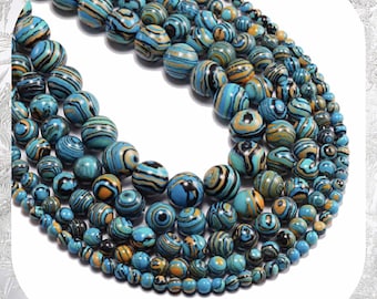 May include: A strand of blue, black, and gold patterned round beads. The beads are arranged in a circle, with the largest beads in the center and the smallest beads on the outside.