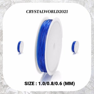 May include: A spool of blue elastic cord, with two smaller spools of the same cord on either side. The text "CRYSTALWORLD2021" is printed above the large spool. The text "SIZE: 1.0/0.8/0.6 (MM)" is printed below the spools.