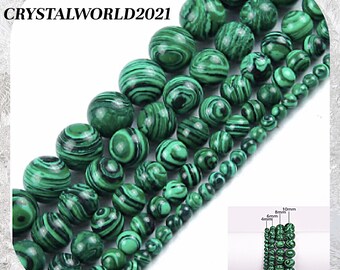 May include: A strand of green malachite beads in various sizes, ranging from 4mm to 10mm. The beads have a swirling, marbled pattern.