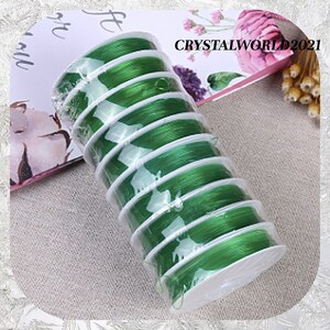 May include: A roll of green elastic string for jewelry making. The string is wound around a white spool and packaged in clear plastic.