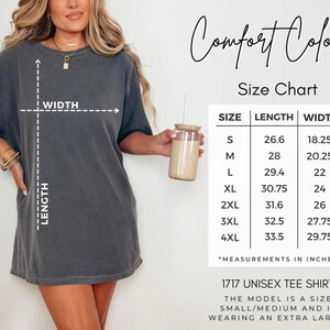 May include: A dark gray unisex tee shirt with a size chart. The chart shows measurements in inches for sizes S to 4XL. The shirt is labeled as a 1717 unisex tee shirt.