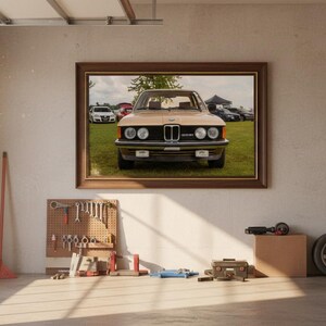 May include: A framed picture of a classic beige car with a black front grill and round headlights. The picture is hanging on a garage wall with tools, a tire, and a pegboard. The garage has a window and a broom.