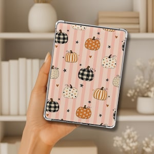May include: A rectangular tablet case featuring a repeating pattern of various pumpkins on a light pink and white vertical striped background. The pumpkins include black and white plaid, orange with white flowers, and white with orange polka dots.